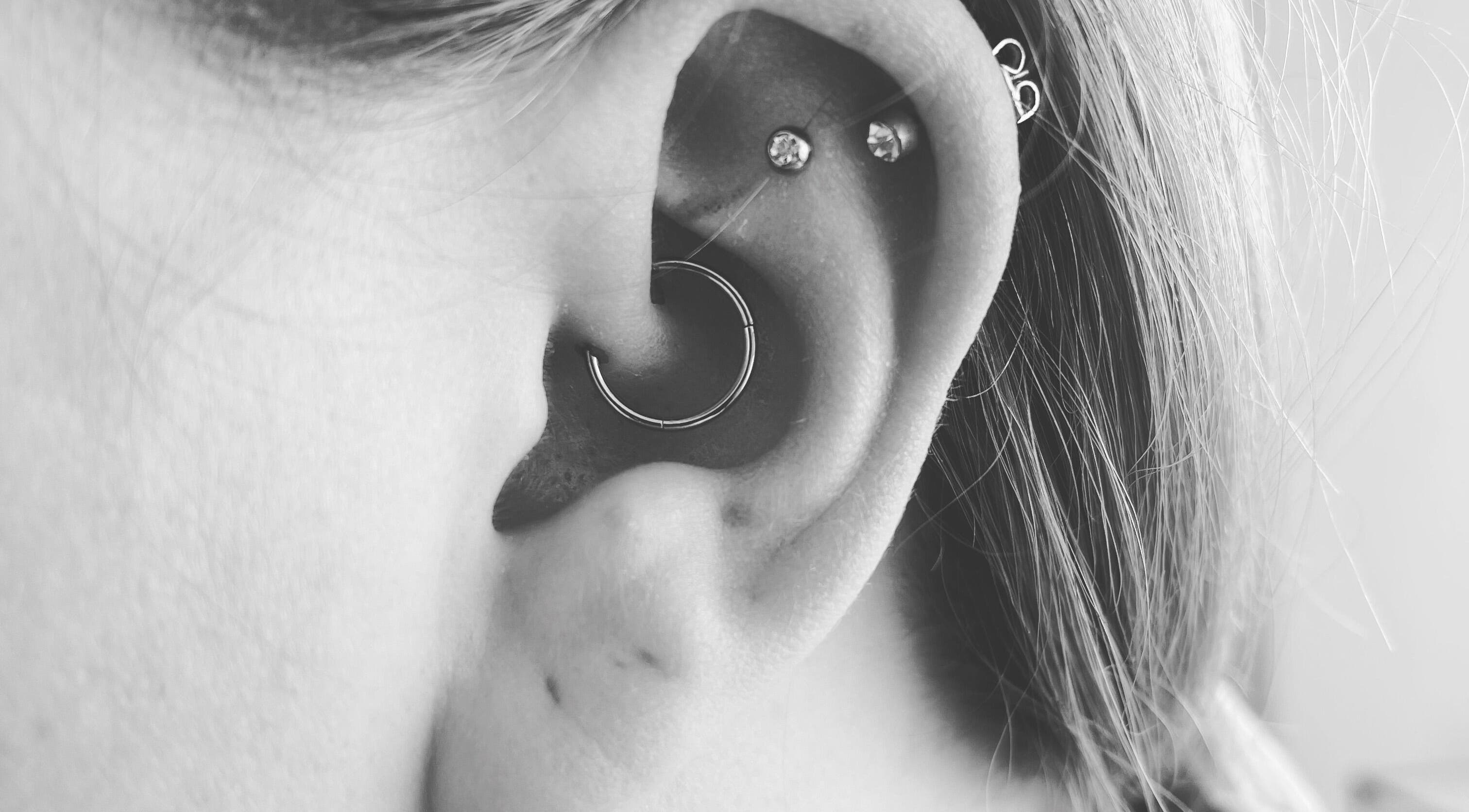 Close-up of ear piercings at Thy Eternal in Hayle, England, GB showcasing stylish jewelry.