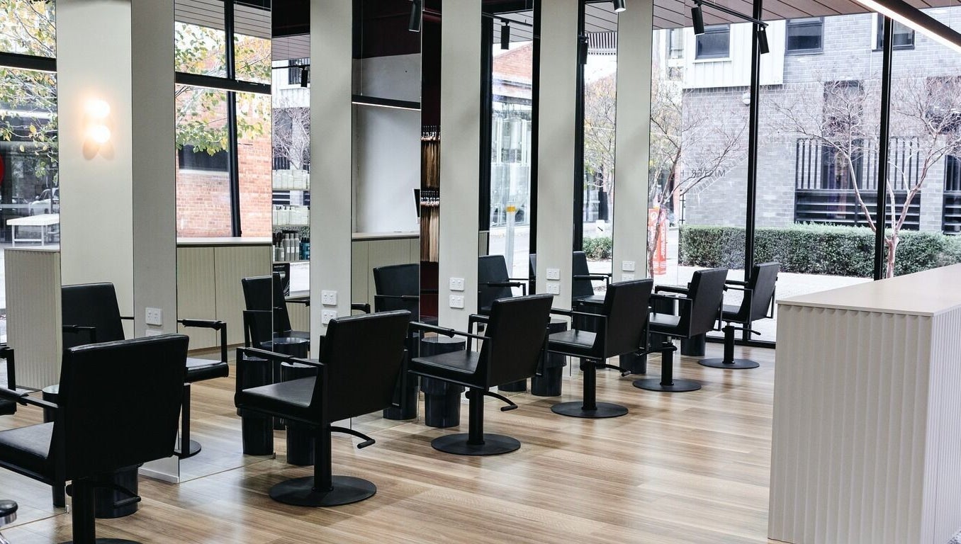 Modern salon chairs at Mister and Her, Bowden, South Australia, AU with sleek design and natural light.