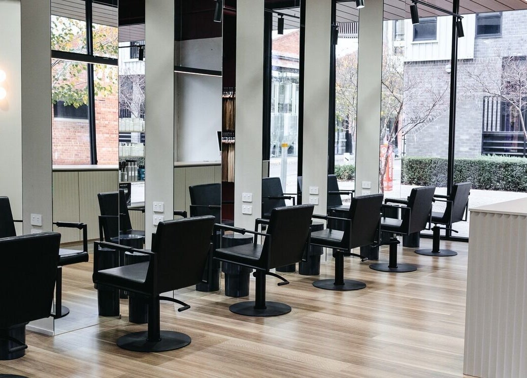 Modern salon chairs at Mister and Her, Bowden, South Australia, AU with sleek design and natural light.