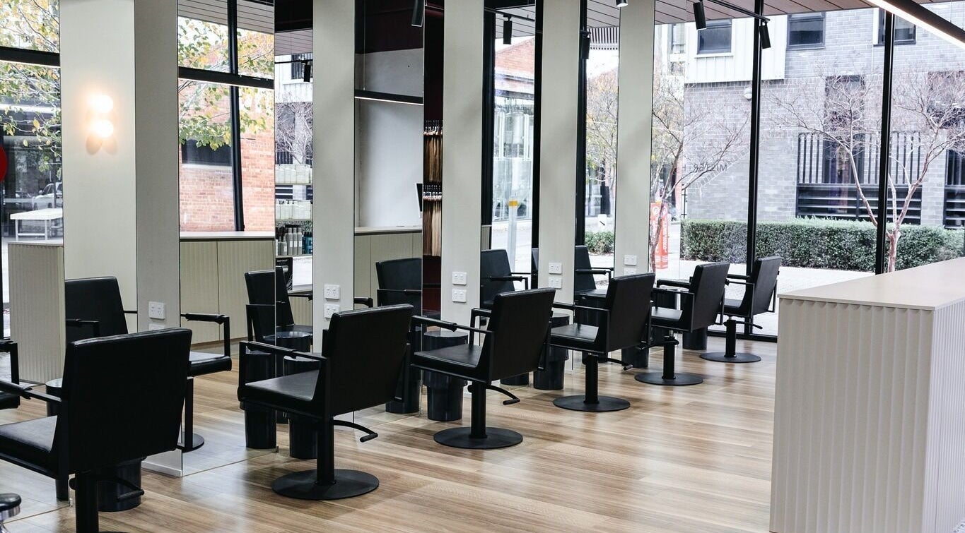 Modern salon chairs at Mister and Her, Bowden, South Australia, AU with sleek design and natural light.