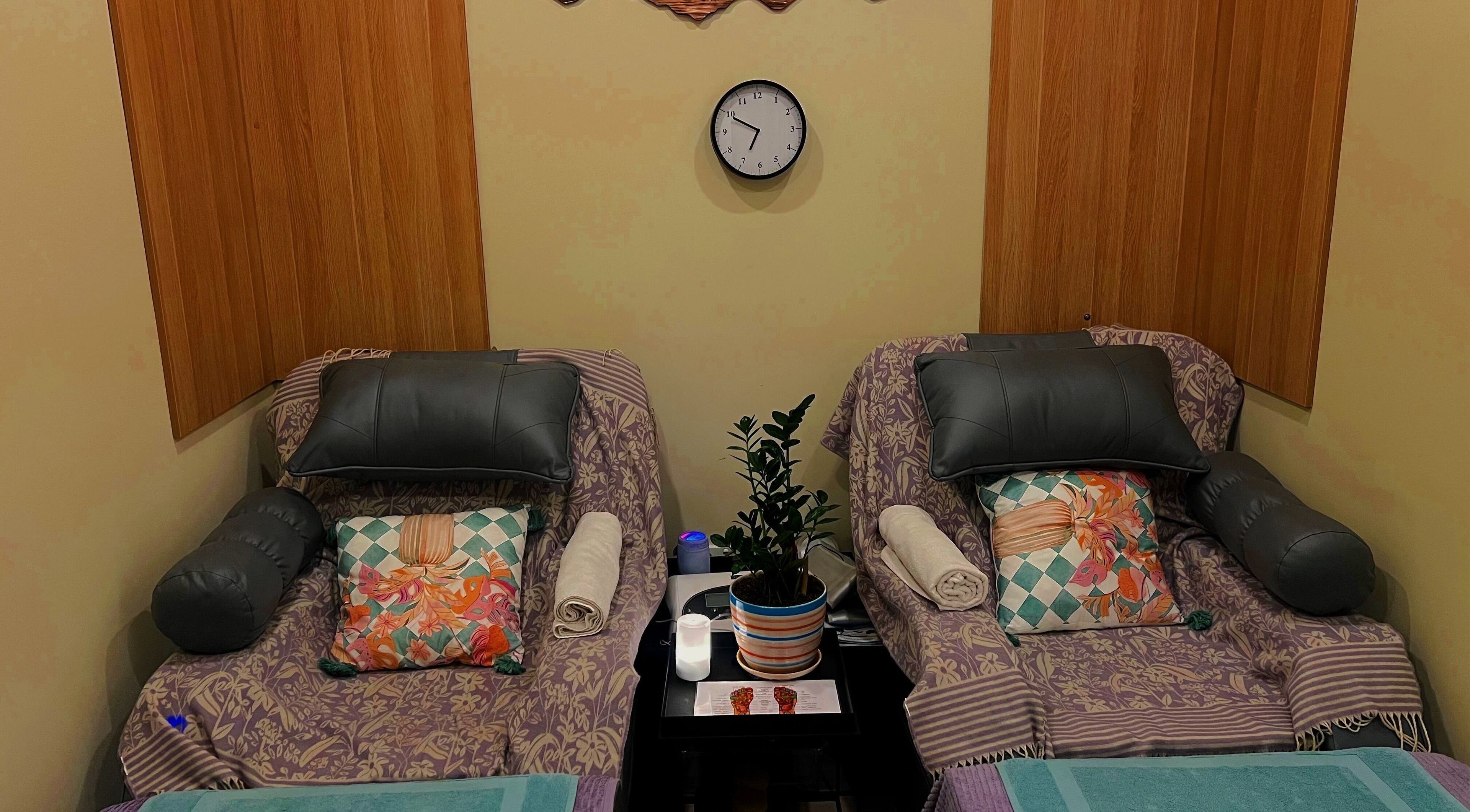 Cozy massage chairs at Massage Legendary in Taigum, Queensland, AU, featuring vibrant pillows and calming decor.