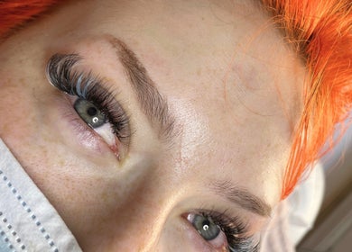 Close-up of eyelash extensions at FREAKlash, Brighton And Hove, England, GB showcasing vibrant orange hair.