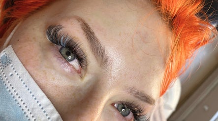 Close-up of eyelash extensions at FREAKlash, Brighton And Hove, England, GB showcasing vibrant orange hair.