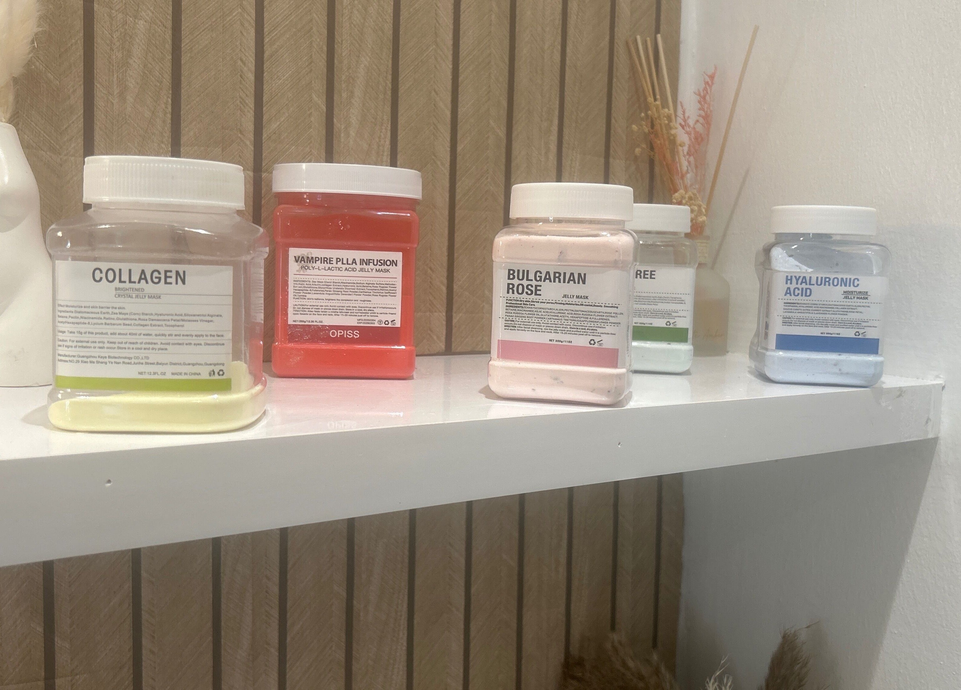 Diverse skincare masks on a shelf at Sculptmebyjord, Ilford, England, GB, highlighting beauty treatments.