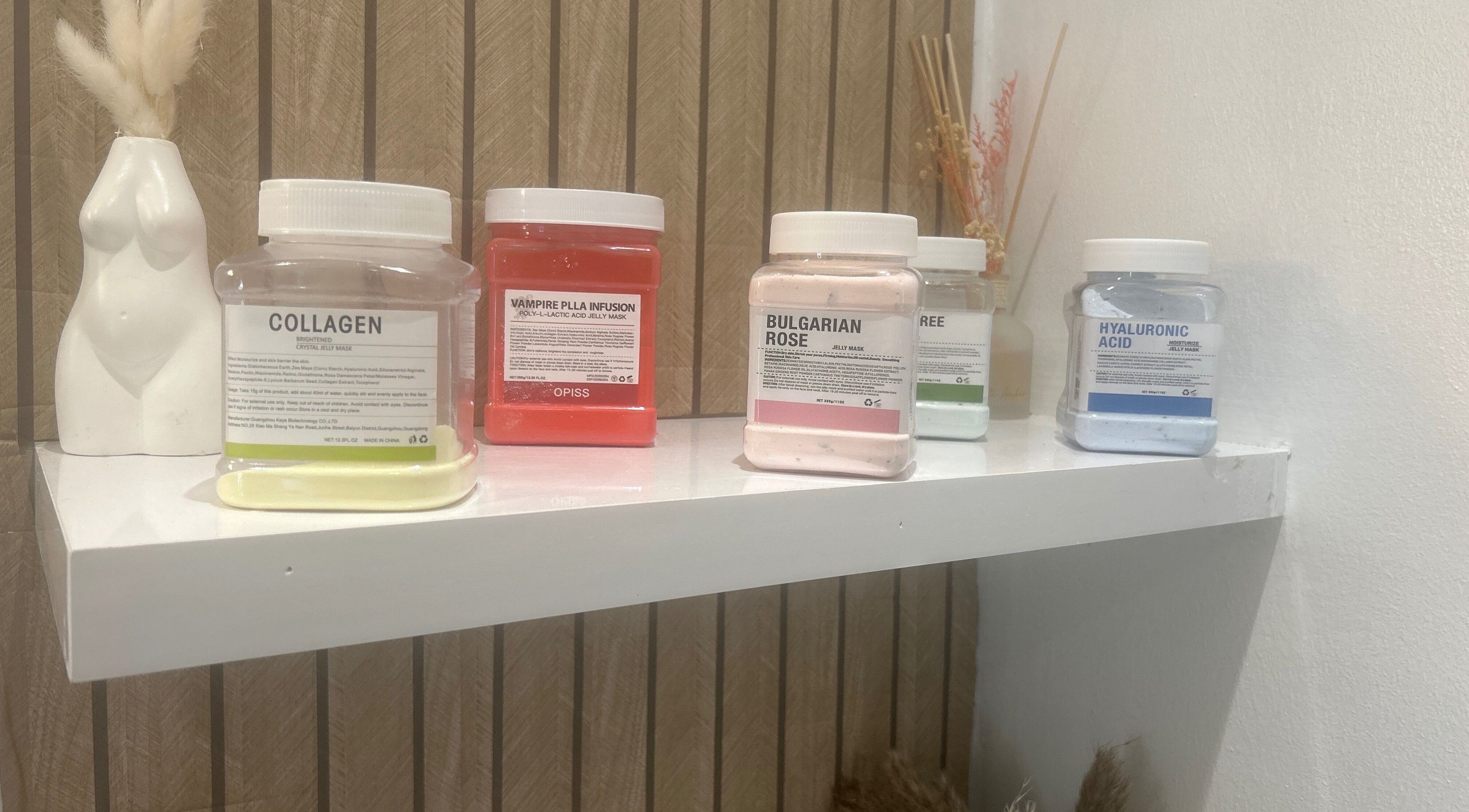 Diverse skincare masks on a shelf at Sculptmebyjord, Ilford, England, GB, highlighting beauty treatments.