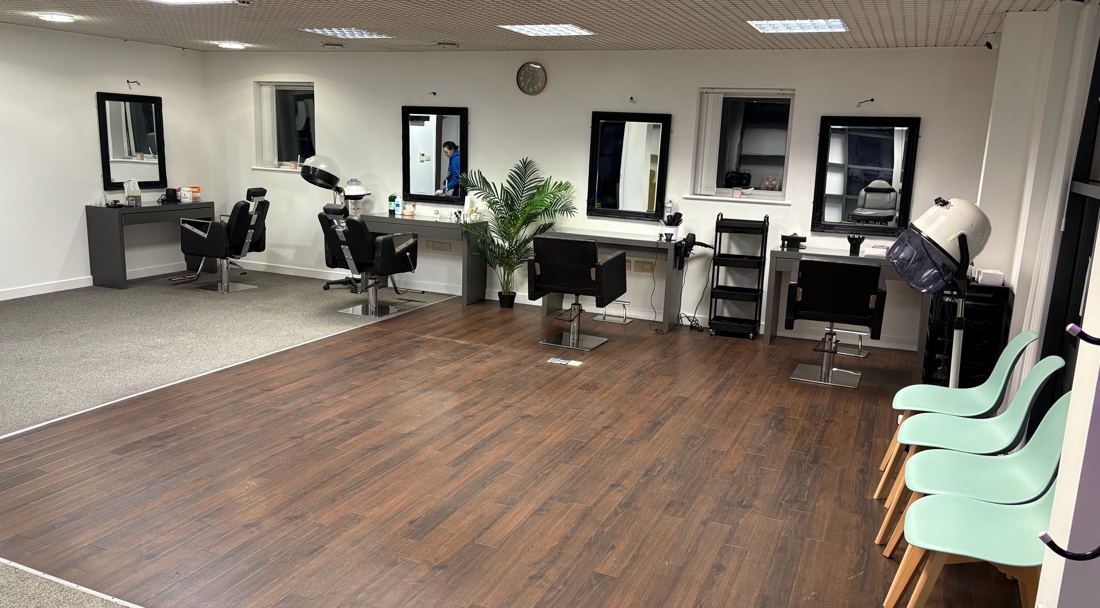Spacious interior of Shingaar Hair-Beauty & Training Academy, Birmingham, England, GB, with modern styling stations.