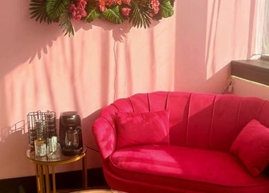 Chic pink sofa and coffee station at Nailed It Sis, Stafford, England, GB, creating a welcoming ambiance.