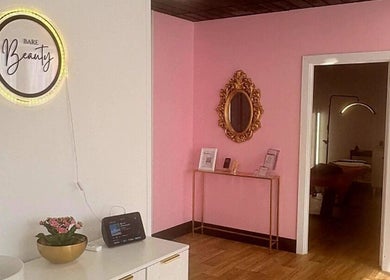 Chic interior of Nailed It Sis in Stafford, England with pink walls and elegant decor.