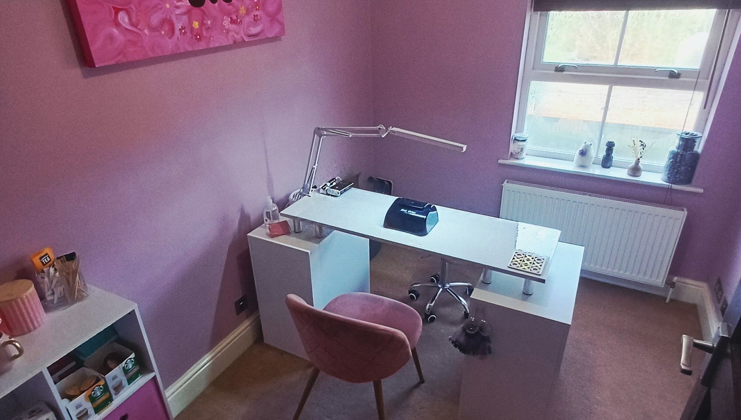 Elegant nail studio at Nailed It Sis in Stafford, England, GB with pink decor and modern manicure station.