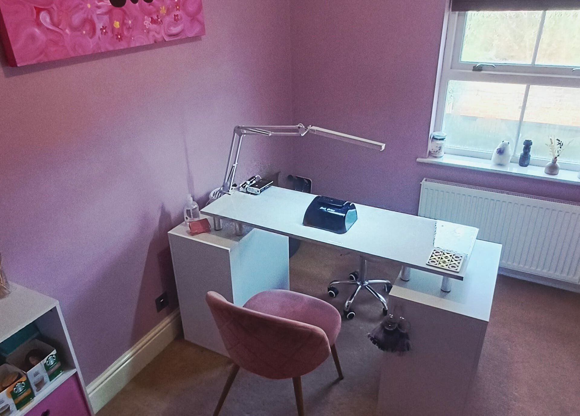 Elegant nail studio at Nailed It Sis in Stafford, England, GB with pink decor and modern manicure station.