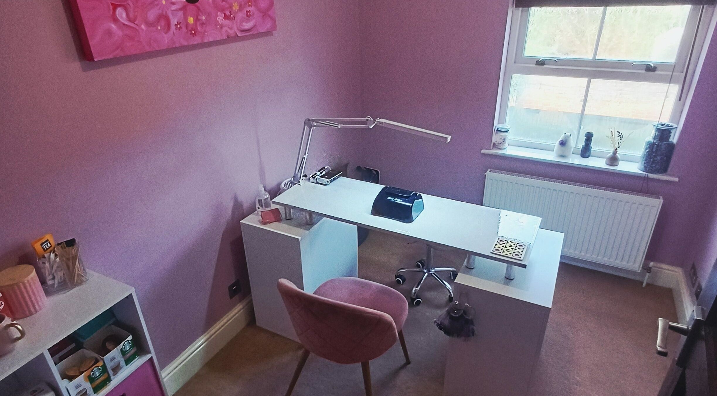 Elegant nail studio at Nailed It Sis in Stafford, England, GB with pink decor and modern manicure station.