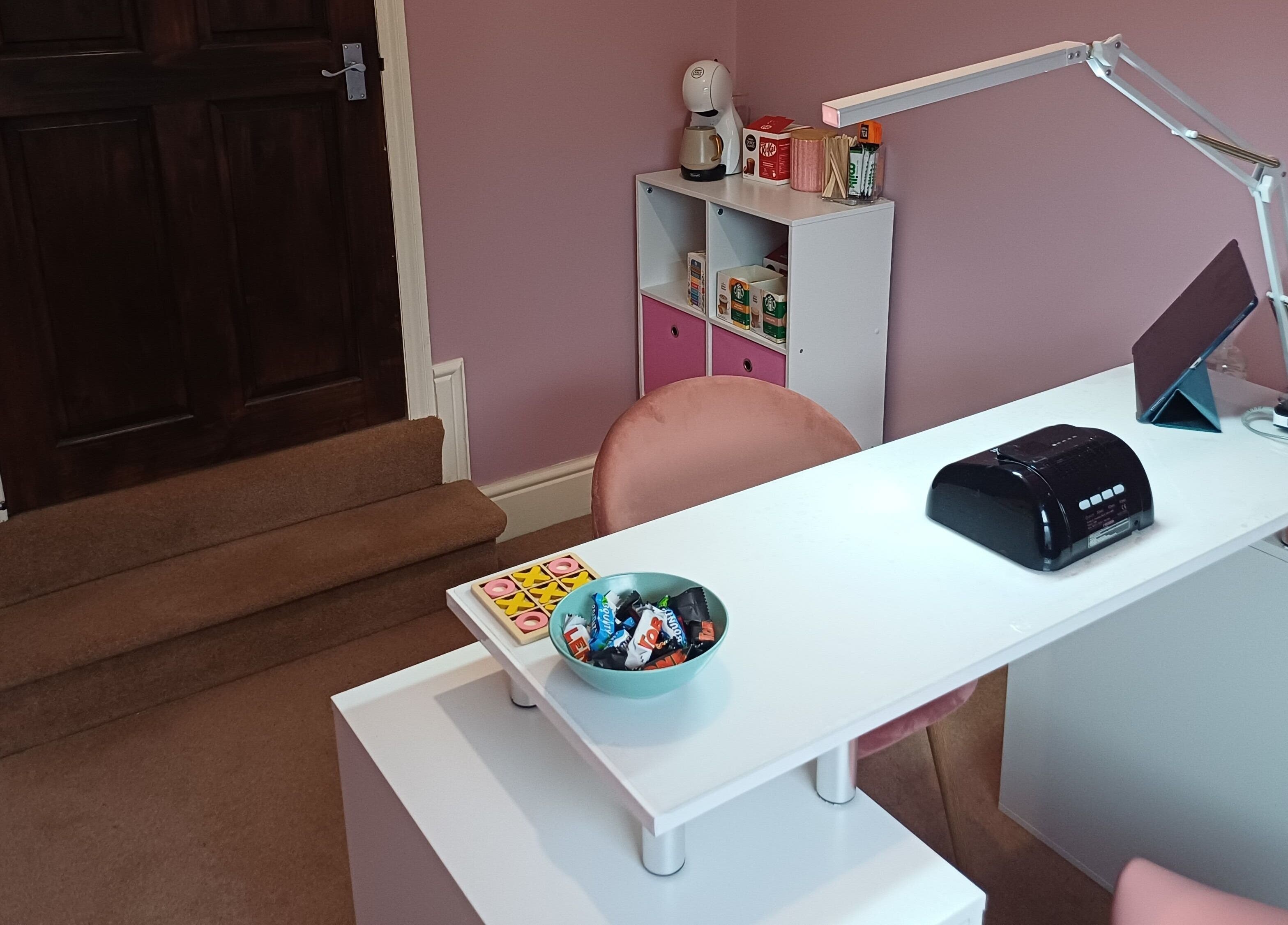 Cozy nail station at Nailed It Sis, Stafford, England, GB. Features a comfortable chair and modern decor.