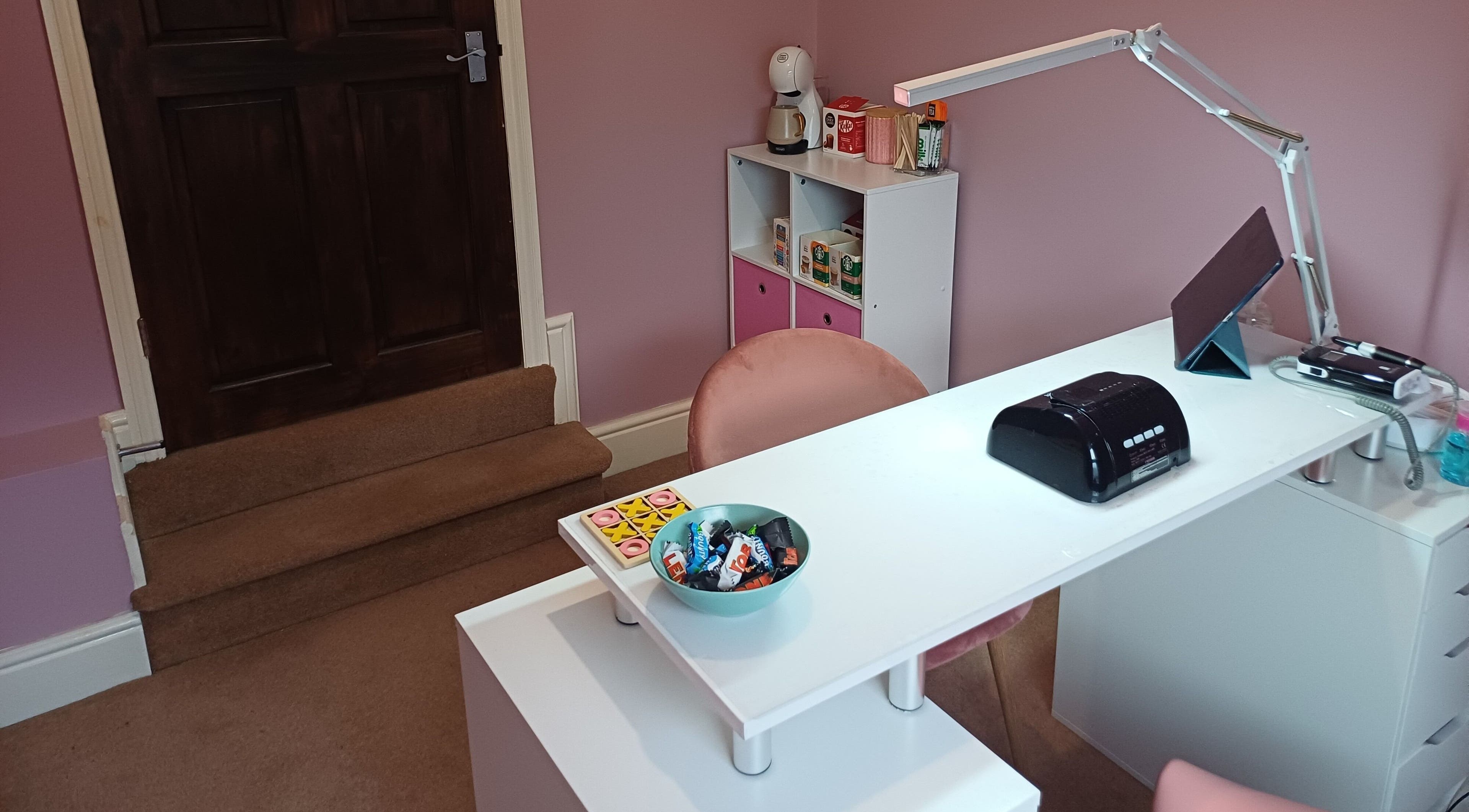 Cozy nail station at Nailed It Sis, Stafford, England, GB. Features a comfortable chair and modern decor.