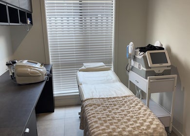 Modern treatment room at Nude Confidence, Pimpama, Queensland, AU featuring spa bed and equipment.