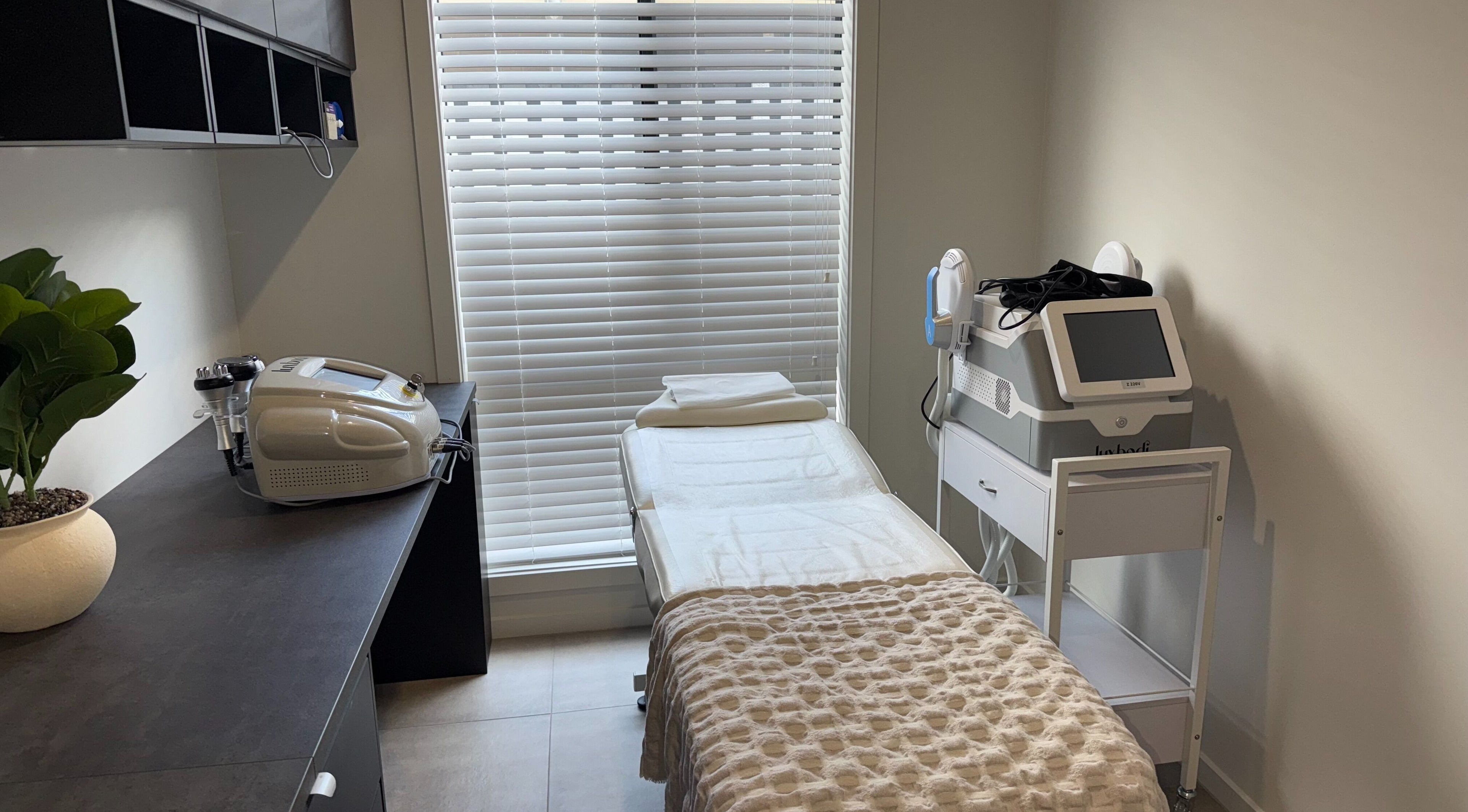 Modern treatment room at Nude Confidence, Pimpama, Queensland, AU featuring spa bed and equipment.