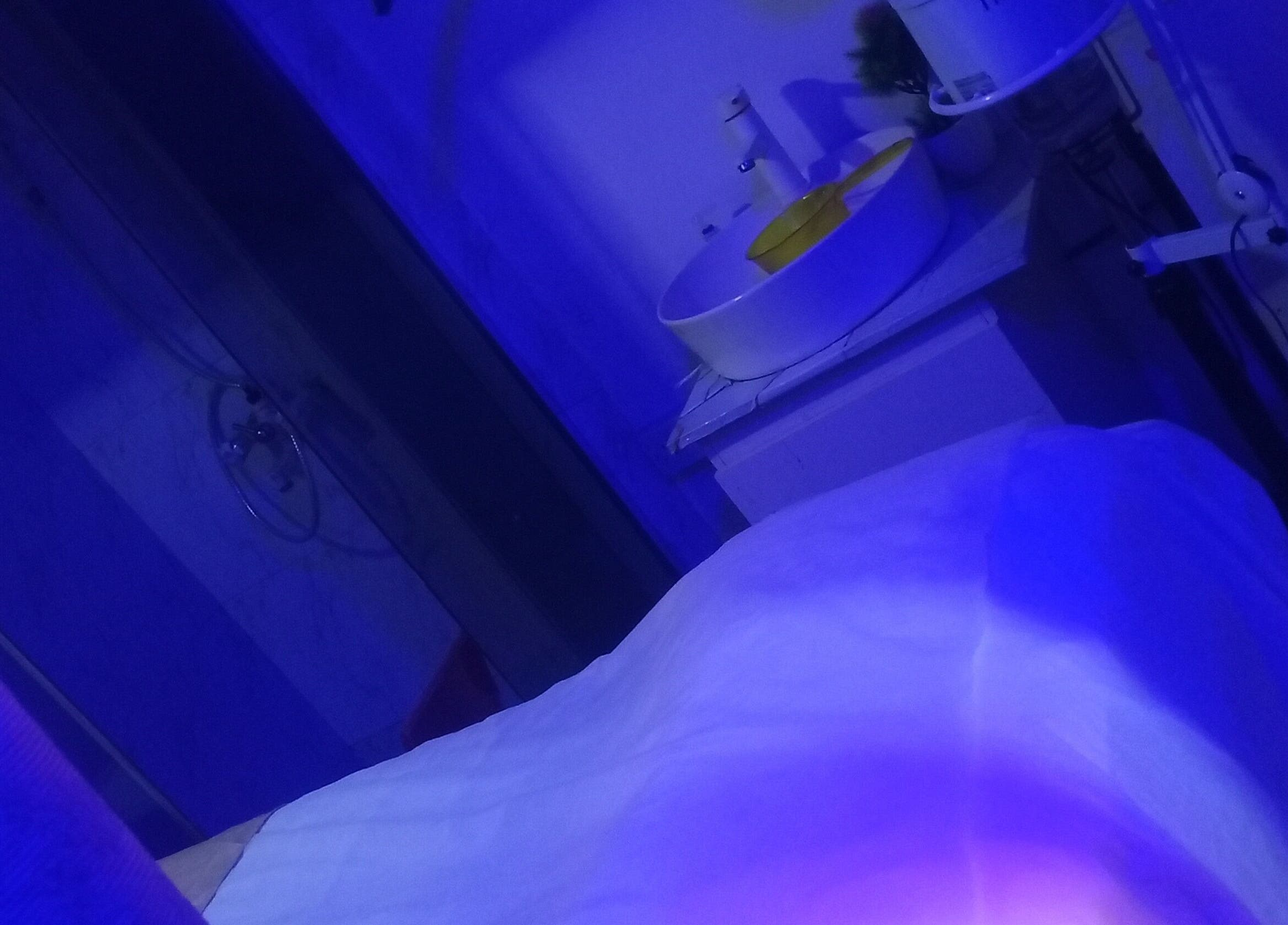 Calming spa room at Damme's Wellness, Lagos, Lagos, NG, illuminated with soothing blue lighting.