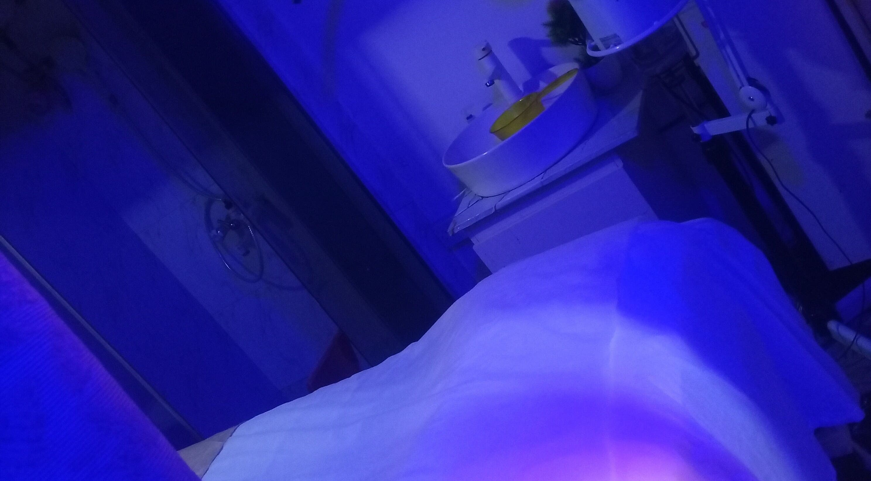 Calming spa room at Damme's Wellness, Lagos, Lagos, NG, illuminated with soothing blue lighting.