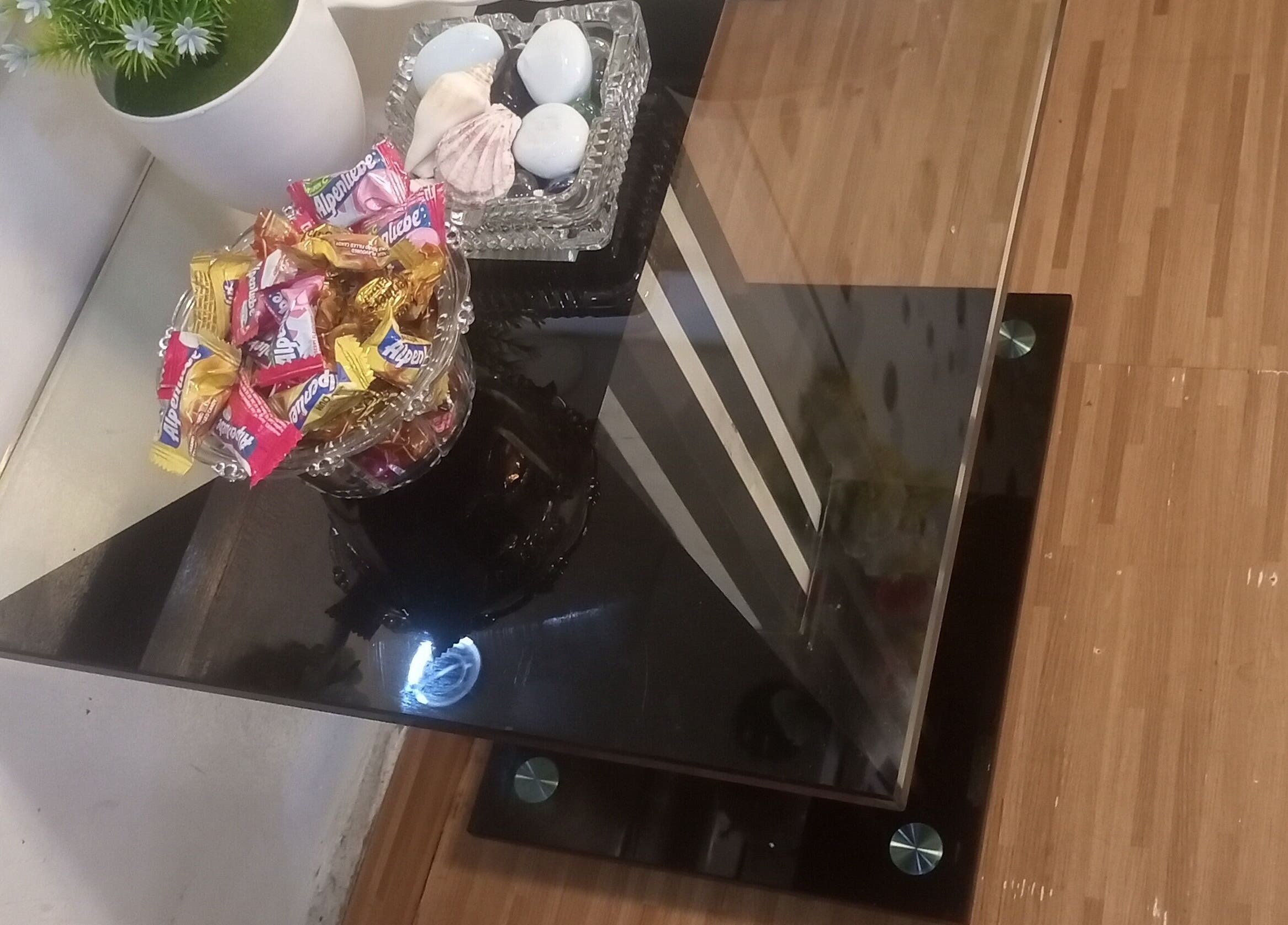 Elegant glass table with candies and decor at Damme's Wellness in Lagos, Lagos, NG.