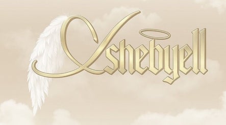 Lashedbyelll logo with golden text and feather, Nottingham, England, GB.