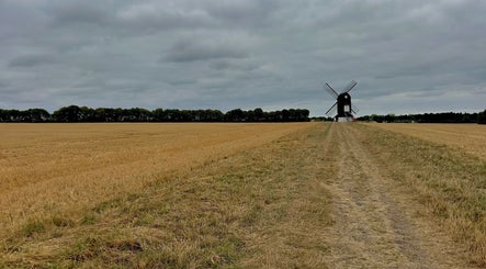 Serene countryside with a windmill near ES Sports Massage in Ivinghoe, England, GB.