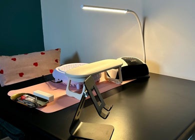 Manicure station at Nailed By Amii, Leeds, England, GB, featuring a lamp and tools on a sleek black table.