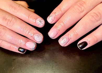 Creative nail art with star and spiral motifs at Nailed By Amii, Leeds, England, GB.