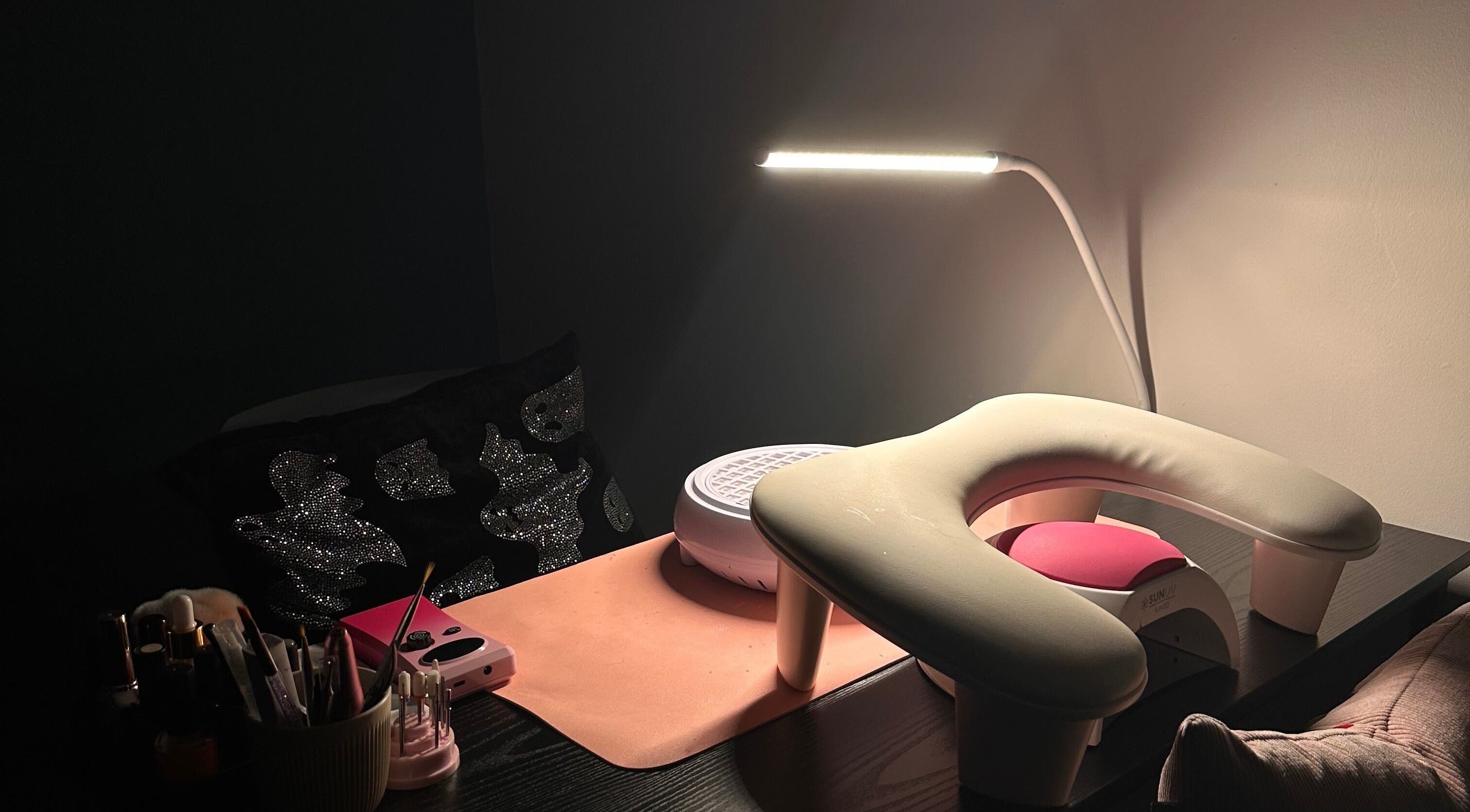 Nail station at Nailed By Amii, Leeds, England, GB, showcasing tools and a lamp ready for a manicure.