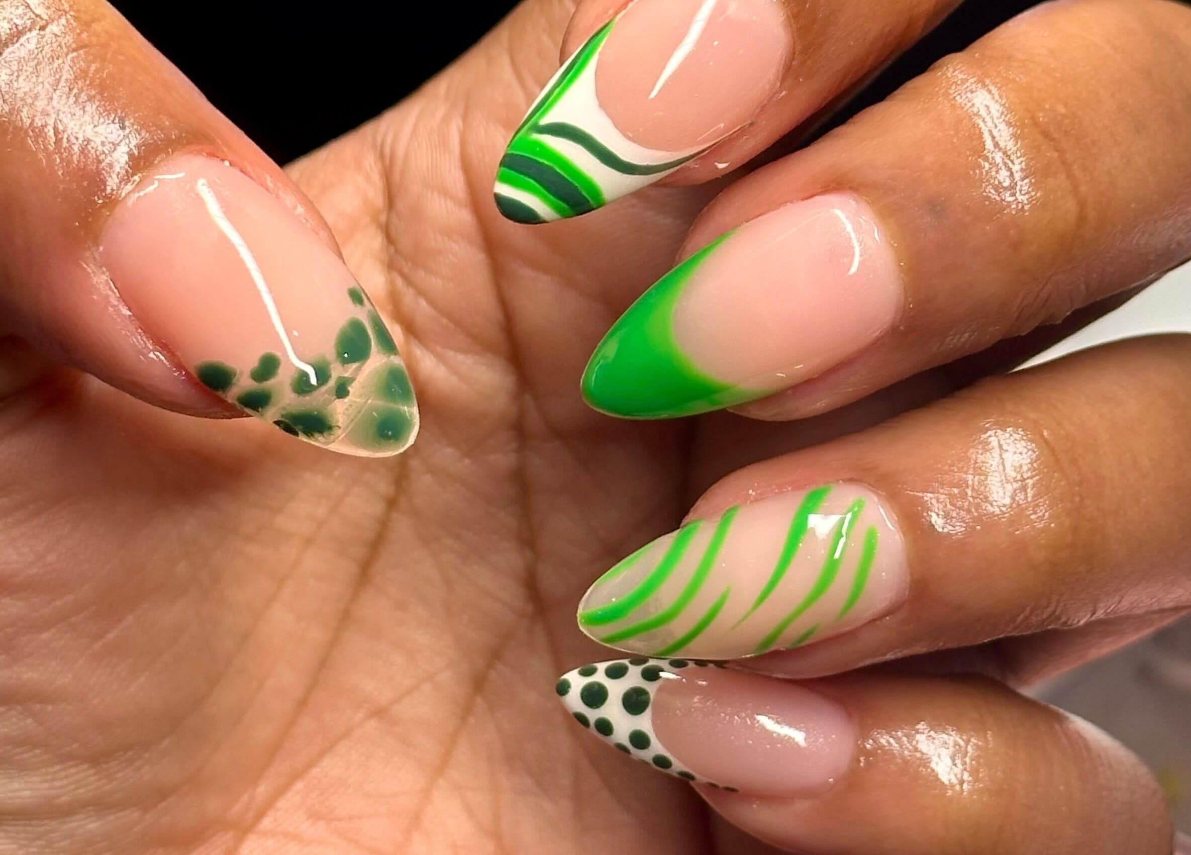 Close-up of artistic green nail designs at Nailed By Amii, Leeds, England, GB.