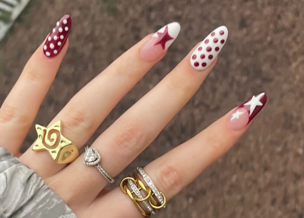 Creative nail design with stars and polka dots by Nailed By Amii in Leeds, England, GB.