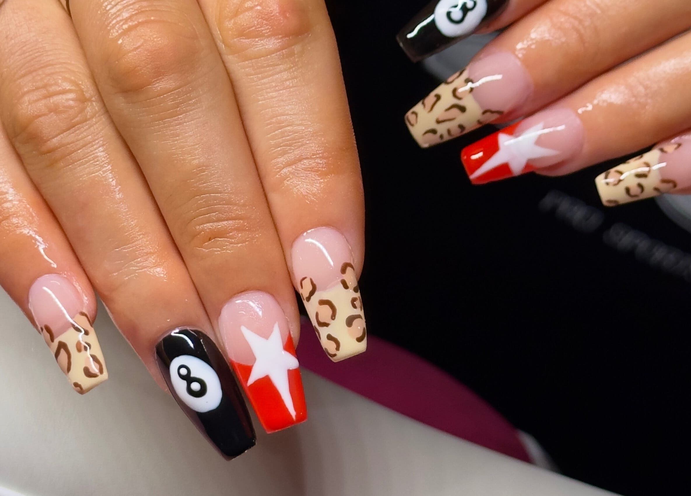 Stylish nail art at Nailed By Amii, Leeds, England, GB, featuring leopard and star designs.