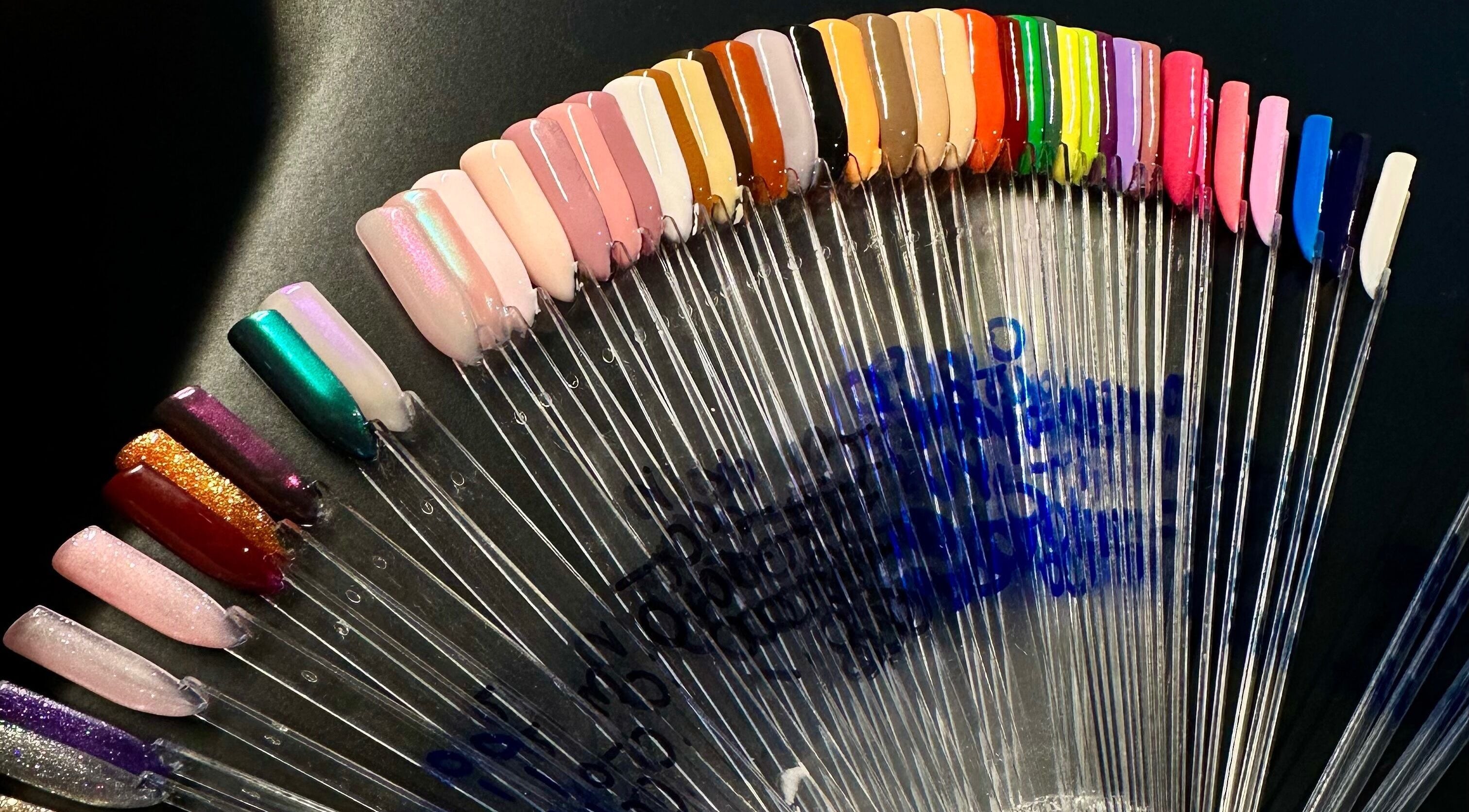 Colorful nail polish swatches at Nailed By Amii, Leeds, England, GB showcasing vibrant manicure options.