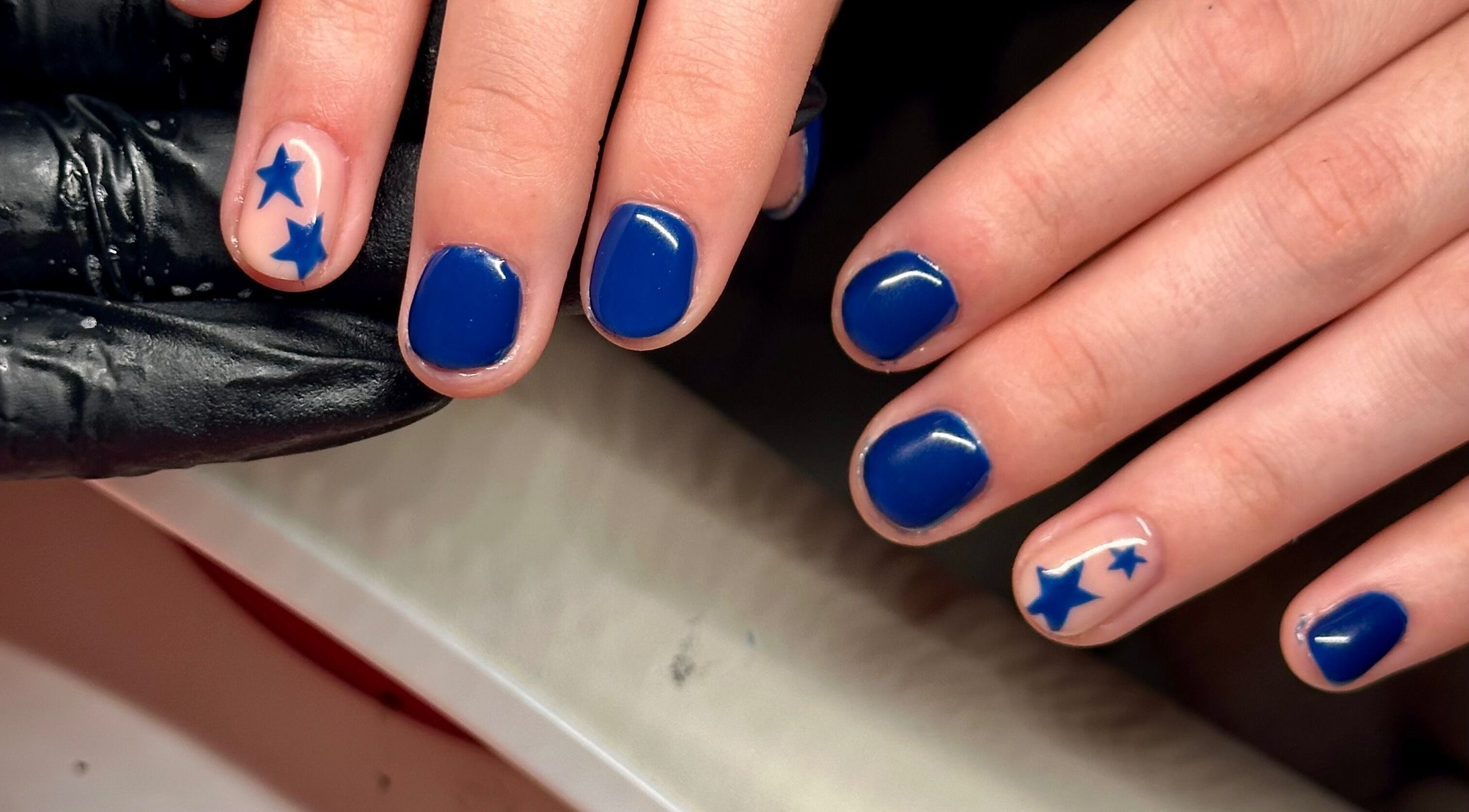 Blue star nail art at Nailed By Amii, Leeds, England, GB showcasing creative manicure design.