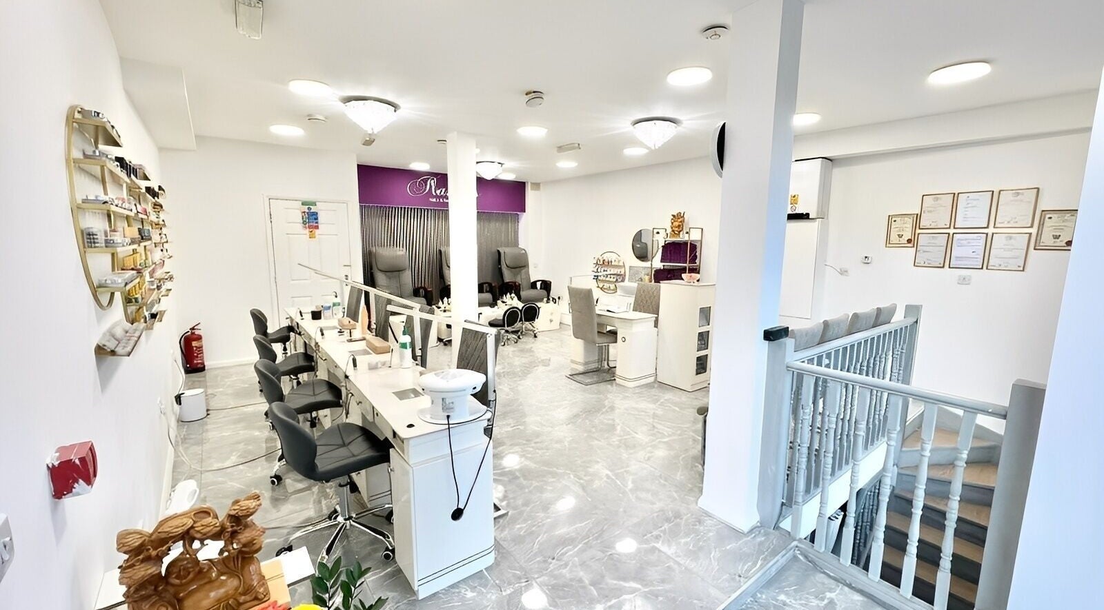 Interior of Flawless Nails & Beauty Lounge, London, England, GB, featuring sleek nail stations and modern decor.