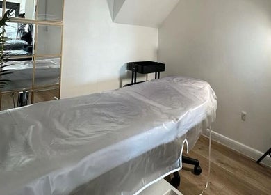 Relaxing treatment room at Stript Aesthetics Clinic Limited, Orpington, England, GB, featuring a cozy setup.