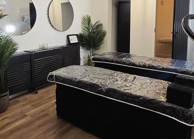 Stylish treatment room at Stript Aesthetics Clinic Limited, Orpington, England, GB. Modern decor and plush beds.
