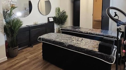 Stylish treatment room at Stript Aesthetics Clinic Limited, Orpington, England, GB. Modern decor and plush beds.
