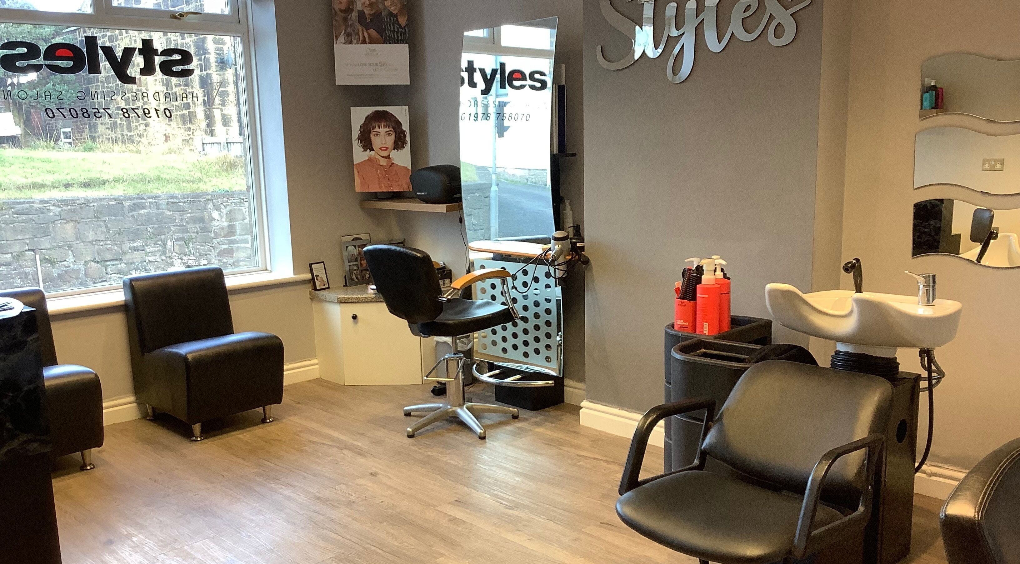 Bright interior of Styles Hairdressing Salon in Coedpoeth, Cymru, GB showcasing modern seating and styling stations.