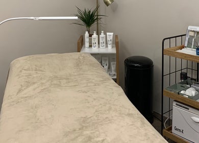 Cozy treatment bed at WildRose Natural Beauty Studio in Fladbury, England, GB, with skincare products displayed.