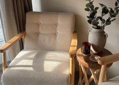 Cozy seating with a vase and candle at WildRose Natural Beauty Studio, Fladbury, England, GB.