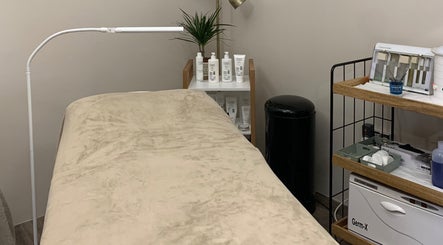 Cozy treatment room at WildRose Natural Beauty Studio in Fladbury, England, with soothing decor and beauty products.