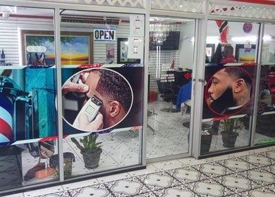 Entrance of Red Beard Barbering Studio in Port of Spain, showcasing vibrant barber-themed graphics.