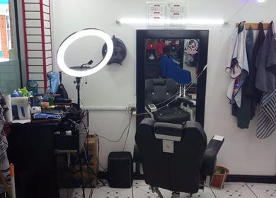 Interior of Red Beard Barbering Studio in Port of Spain, TT, featuring barber chair and styling tools.