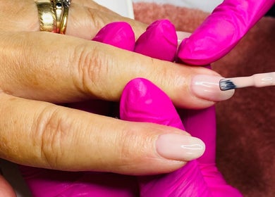 Nail technician applying polish at Le Studio Rituel des Ongles, Bergerac, Nouvelle-aquitaine, FR.