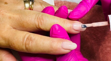 Nail technician applying polish at Le Studio Rituel des Ongles, Bergerac, Nouvelle-aquitaine, FR.