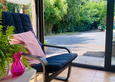 Cozy chair by window at Le Studio Rituel Des Ongles, Bergerac, Nouvelle-Aquitaine, FR.