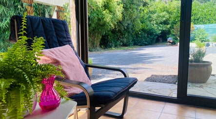 Cozy chair by window at Le Studio Rituel Des Ongles, Bergerac, Nouvelle-Aquitaine, FR.