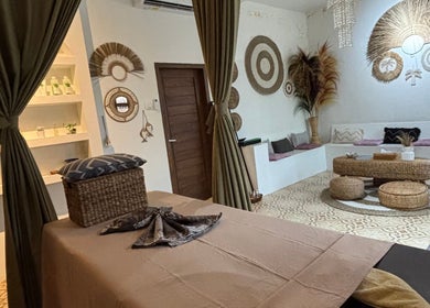 Relaxing spa room at Chellvan_spa in Bali, Bali, ID with earthy decor and comfortable seating.