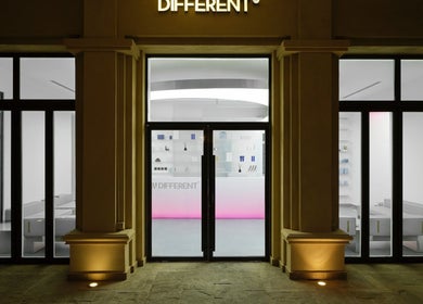 Front view of DIFFERENT Clinic's elegant entrance in Abu Dhabi, Abu Dhabi, AE with modern lighting and glass doors.