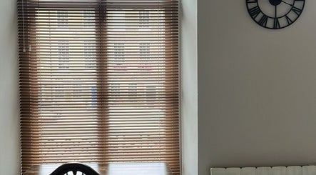 Serene window view through wooden blinds at Palms of Health, London, England, GB, enhancing relaxation.