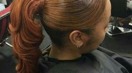 Sleek red ponytail hairstyle at RF368 Beauty Bar in Waterbury, Connecticut, US.